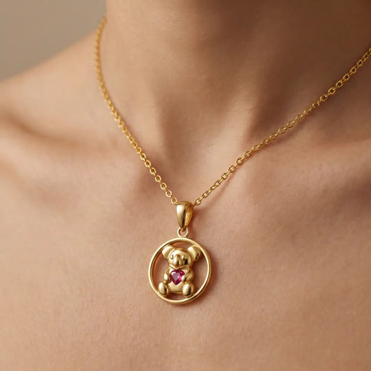 18 Gold vermeil necklace with a Koala pendant and ruby heart shape cz on a person's neck.