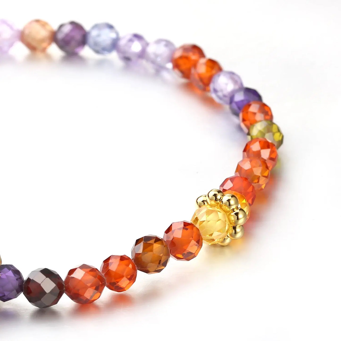 Multi-colored beaded bracelet with a gold ring on a white background