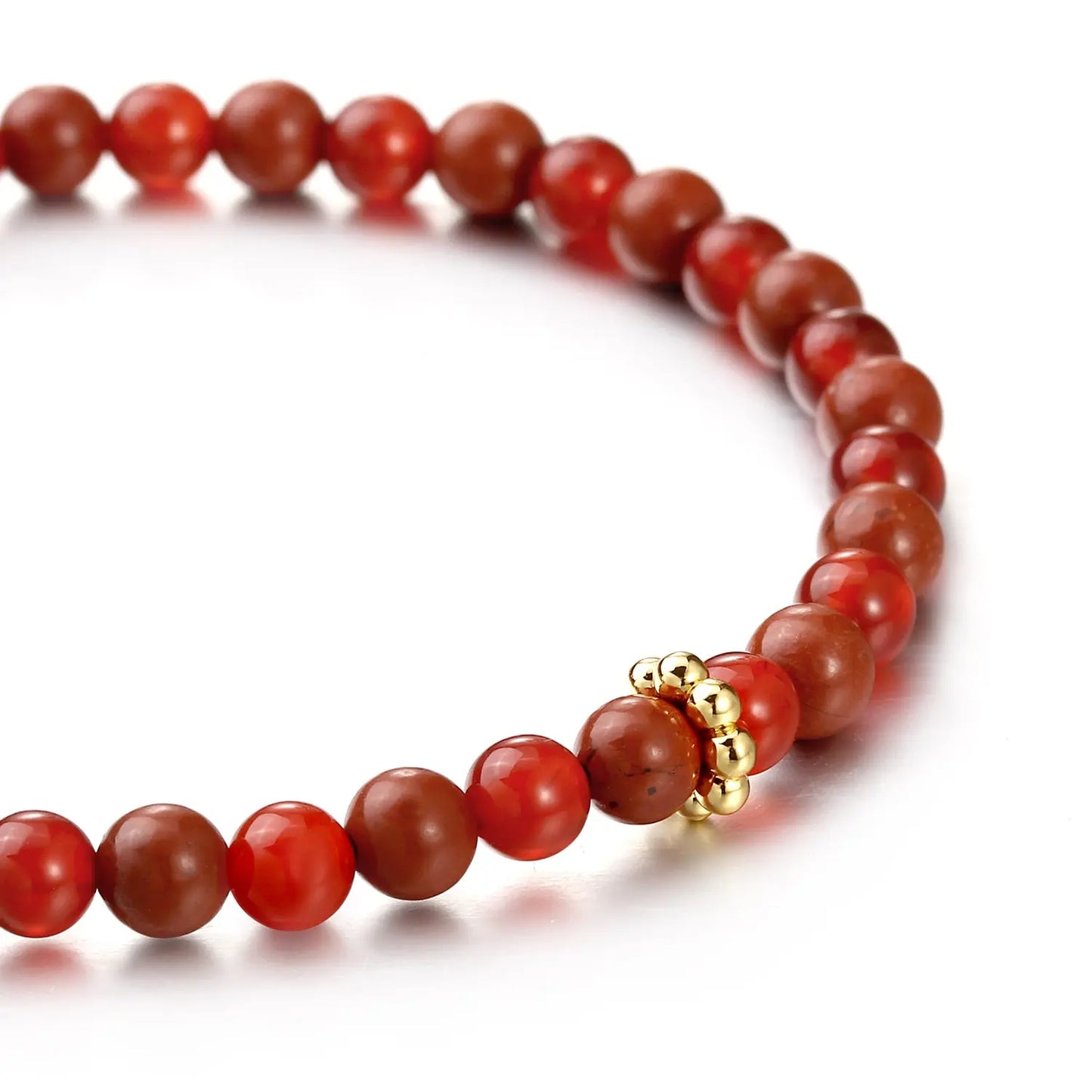 Red beaded bracelet with gold accents on a white background