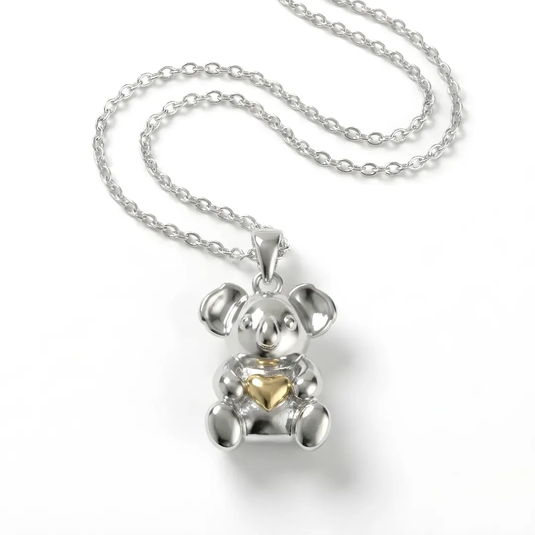 Silver Koala pendant with a 10k gold heart on a white background