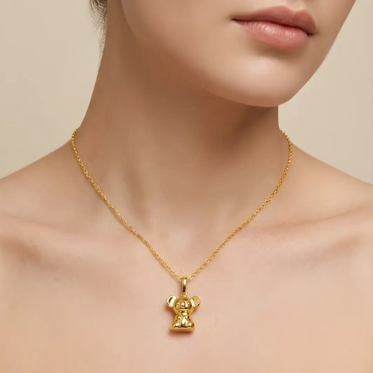18k Gold vermeil necklace with a 3d Koala pendant worn by a model on a beige background