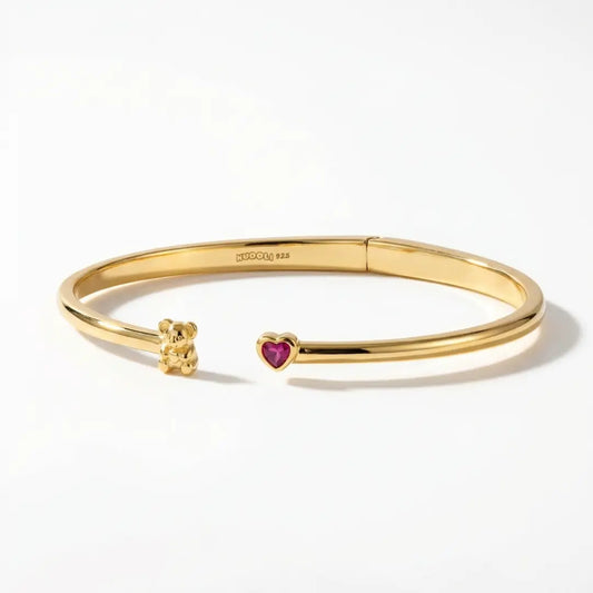 Gold bracelet with a Koala charm and heart-shaped ruby cz on a white background