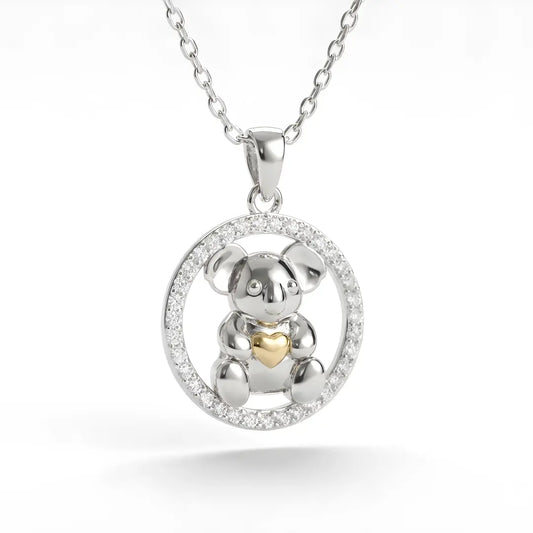 Silver Koala pendant with a 10k gold heart circle cz on a white background