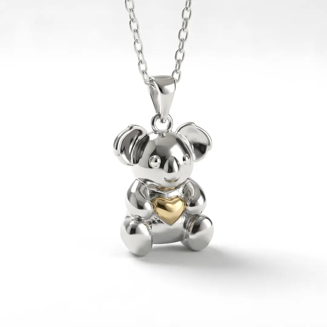 Silver Koala pendant with a 10k gold heart on a white background