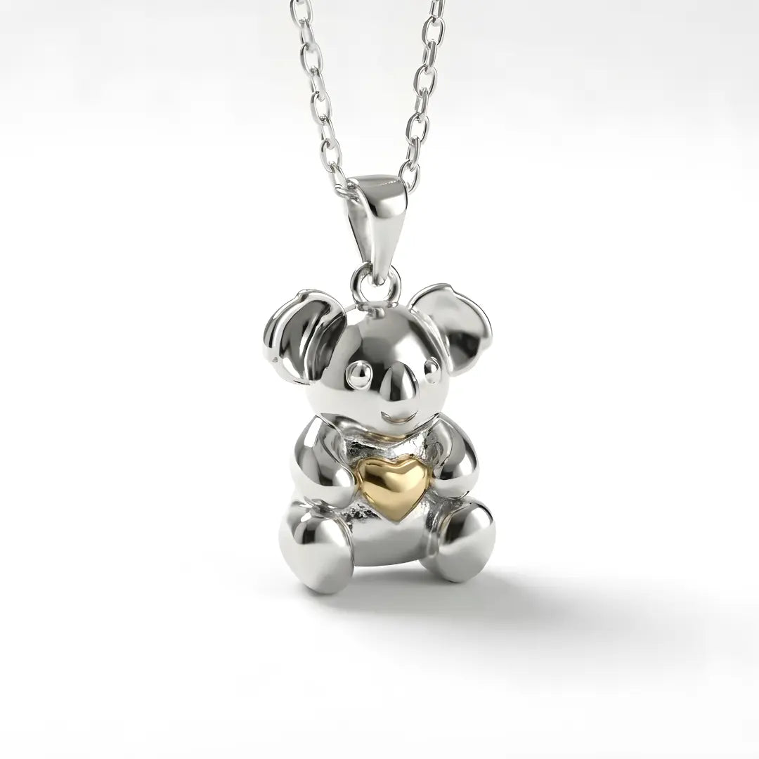 Silver Koala pendant with a 10k gold heart on a white background