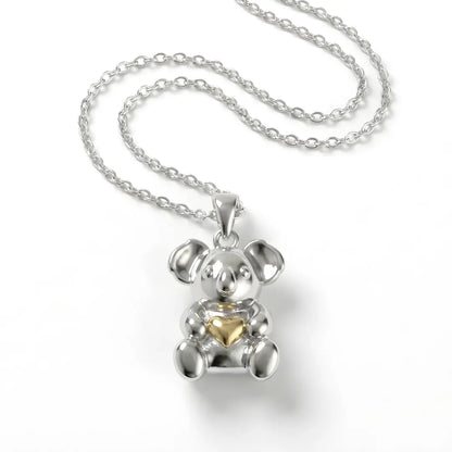 Silver Koala pendant with a 10k gold heart on a white background