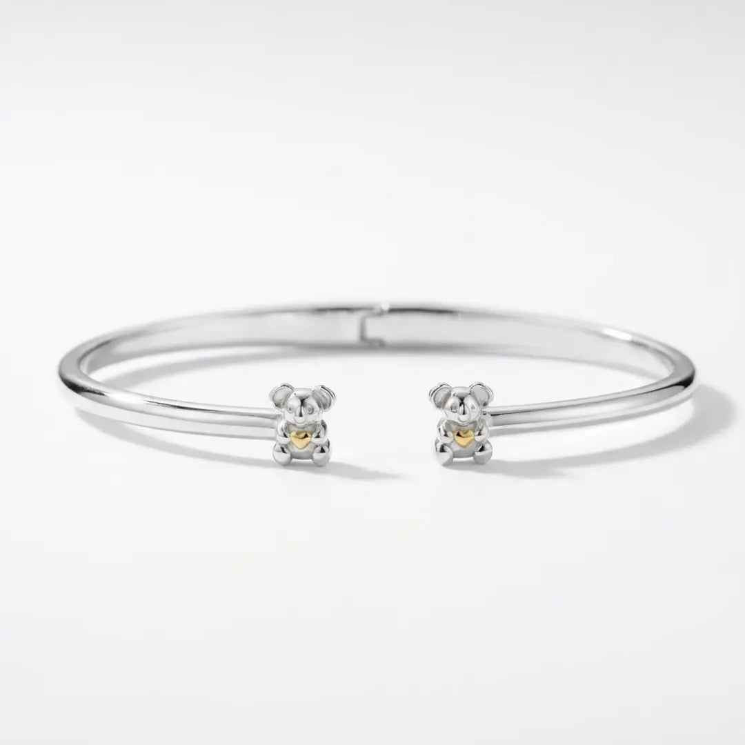 Silver bangle with Koala charms on a white background