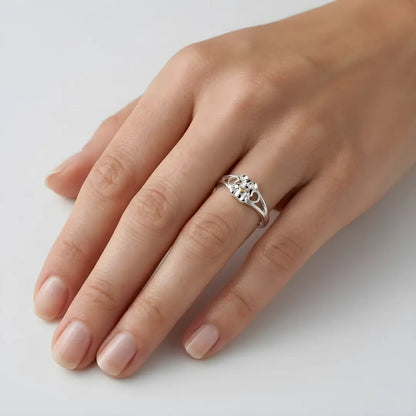 Silver Koala ring on a person's finger against a white background