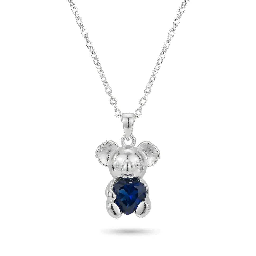 Silver Koala pendant with a Sapphire heart-shaped CZ on a white background